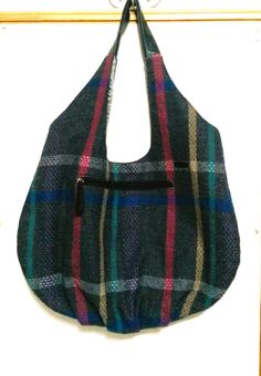 Large hobo bag with boho colors and features is 13.5" high at center of bag above the outside zipper by 21" wide at its widest point. The bag is made of gray tweed plaid.  Colors are gray, pink, blue, purple and teal. There are 2 zipper pockets; one exterior and one interior.  The recycled handle fits the purse perfectly.  Bag is made from the Diana Tote Bag Pattern by Delinda Boutique. Lining is gray taffeta. Use for book bag, knitting or crochet bag, lunch bag, gift bag, shopping bag, everyday bag or whatever you need it for. Bohemian Multicolor Bags For Fall, Bohemian Multicolor Fall Bags, Boho Colors, Large Hobo Bag, Bag Knitting, Bag Lunch, Grey Tweed, Tote Bag Pattern, Book Bag