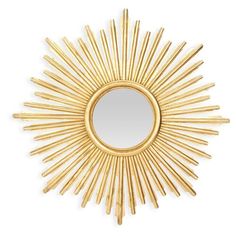 a gold sun mirror on a white wall