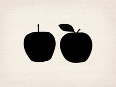 two black apples sitting side by side on a white background