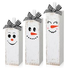 three wooden boxes with snowmen painted on them