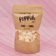 a bag of popcorn sitting on top of a pink table