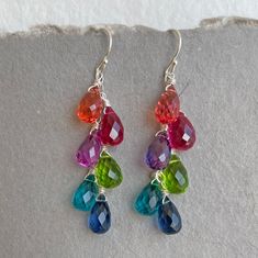 "These will brighten up any day! Stunning bright quartz briolettes wire wrapped in sterling wire on sterling ear wires. These can also be done can be done with clip on ear wires or lever backs and on gold upon request. ( PURCHASE LEVERBACK upgrade here: https://www.etsy.com/listing/150621935/leverback-upgrade-lever-back-gold-filled?ga_search_query=leverback&ref=shop_items_search_4 ) The entire earring length is 1 .75\" apprx. Your earrings will arrive beautifully giftwrapped. More EARRINGS h Jewel Tone Rainbow, Trendy Jewelry Ideas, Color Quartz, Multicolor Earrings, Earring Gift, Rainbow Earrings, Button Jewelry, Beaded Bracelets Diy, Sterling Silver Hoop Earrings