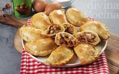 a white plate topped with pastries on top of a red and white checkered table cloth