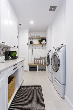 a washer and dryer in a white laundry room