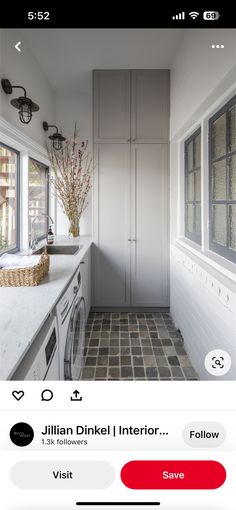 the app is showing an image of a kitchen with white cabinets and tile flooring