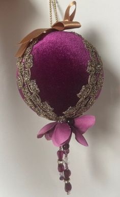 a purple ornament hanging from a wall