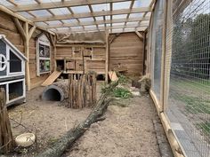 the inside of a chicken coop with an animal house and other animals in it's pen