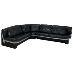 a black leather sectional sofa with chrome legs and backrests on an isolated white background