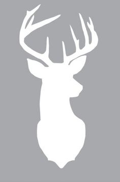 the silhouette of a deer with antlers on it's head, against a gray background