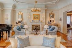 a living room filled with furniture and a piano