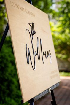 a wooden sign with writing on it that says let the adventure begin and the walrus