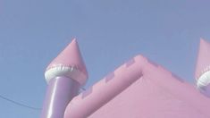 an inflatable pink building with two towers on top