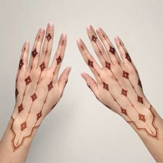 two hands with red and brown designs on them