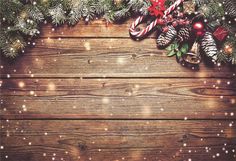 christmas background with pine cones, candy canes and fir tree branches on an old wooden table