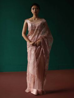 Pre - pleated rosegold organza saree adorned with geometric floral applique'. Set includes pre-pleated saree with petticoat and plain unstitched fabric for blouse. Shell fabric - novel organza base; Appliqué - novel satin Metallic appliqué in our geometric floral pattern. Components - 3 Please note: Stitched blouse is not included. Pink Organza Party Wear Pre-draped Saree, Formal Bollywood Organza Pre-draped Saree, Formal Organza Pre-draped Saree For Diwali, Evening Bollywood Organza Saree, Bollywood Style Organza Saree For Evening, Bollywood Style Evening Organza Saree, Bollywood Style Evening Saree In Organza, Evening Saree With Resham Embroidery In Organza, Evening Organza Saree With Resham Embroidery