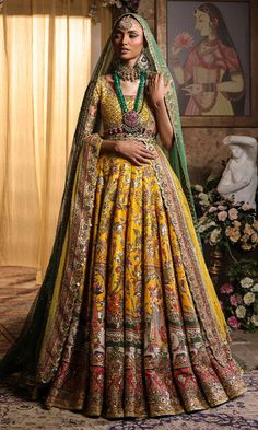 Pakistani Bridal Dress in Yellow Lehenga Choli Style is a classic masterpiece that will give the gorgeous bride a head-turning glamorous look on the most important day of your life. Lavish designs and embellishments give a perfect finishing to this stunning Bridal Lehenga Choli. Lehenga Choli: The choli is in an alluring yellow color is gracefully embellished with intricate designs, zardosi, sequins, tilla, and Resham. Shimmering ornaments, hanging motifs, and lavish contrast of colors make this choli a perfect choice to pair with the Bridal Lehenga. Bridal Lehenga: This Bridal Lehenga is emblazoned with the intricate designs, dabka, tilla, kora, Resham work, sequins, and crystals. The Yellow Lehenga has a huge flare and is adorned with Shimmering details and floral designs, making this Pa Choli Style, Yellow Lehenga Choli, Bridal Lehenga Pakistani, Pakistani Bridal Lehenga, Pakistani Bridal Dress, Yellow Lehenga, Pakistani Wedding Dress, Pakistani Bridal Dresses, Bridal Lehenga Choli