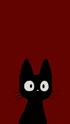 a black cat sitting on top of a red floor next to a white object with big eyes