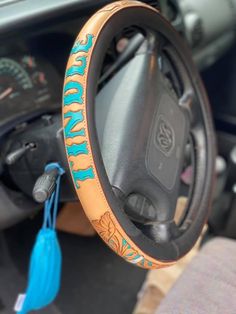 the steering wheel cover is decorated with blue and orange designs