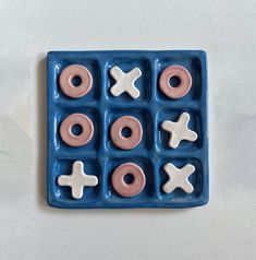 an ice tray with doughnuts and crosses on it, sitting on a white surface