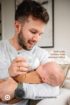 a man holding a baby in his arms