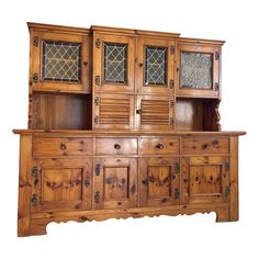 a wooden cabinet with glass doors and drawers