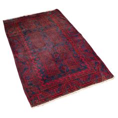 an antique persian rug with red, blue and pink colors on the bottom half of it