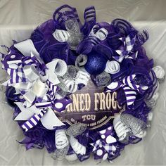 a purple and white mesh wreath that says nerd frog with lots of ribbons around it