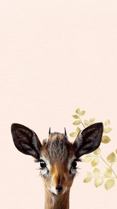 a small deer is standing in front of a pink wall with leaves on it's head