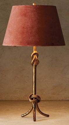 a table lamp with a red shade on it