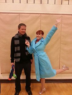 a man and woman dressed up in costume posing for the camera with their arms outstretched