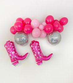 pink boots and balloons on a white background