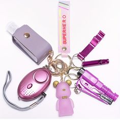 several different types of electronic gadgets on a white surface, including a lighter and keychain