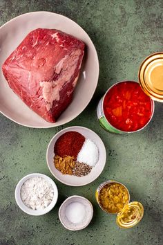 meat, spices and seasonings in bowls on a table