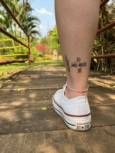 a person's legs with tattoos on them and the words written in black ink