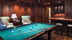 a pool table and chairs in a room with wood paneling