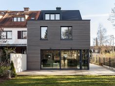 a large house with lots of windows in the front yard