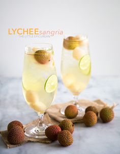 two glasses filled with lemonade, lime and kiwis on top of a cloth