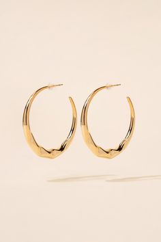 These captivating earrings feature a unique abstract design that adds a contemporary touch to your ensemble. The glossy finish enhances the modern aesthetic, catching the light and reflecting a subtle shine. The open hoop design adds an element of elegance and versatility, making these earrings suitable for both casual and formal occasions. SizeHeight: 1.75 in (4.45 cm)Width: 1.75 in (4.45 cm) Quality Made of a strong metal alloy, ensuring its longevity and quality. Secured with a post backing m Modern Small Hoop Metal Earrings, Modern Metal Open Circle Hoop Earrings, Modern Small Hoop Earrings For Party, Modern Metal Small Hoop Wrap Earrings, Modern Metal Small Hoop Earrings, Modern Small Hoop Earrings, Modern Pierced Hoop Wrap Earrings, Modern Hoop Wrap Earrings, Modern Hoop Earrings For Party