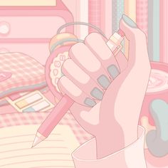 a hand holding a pink pen in front of a bed with lots of stuff on it