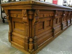 a large wooden table with many carvings on it