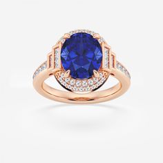 a tan gold ring with a blue sapphire surrounded by diamonds