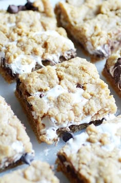 chocolate chip cookie bars with white frosting on top