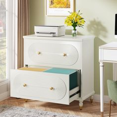 a white dresser with two drawers and a printer on top