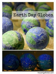 paper mache globes sitting on top of a table next to blue and green balls