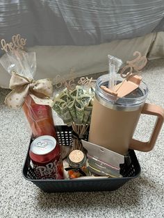 a basket filled with drinks and snacks on the floor