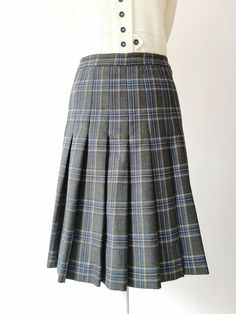 Vintage Wool Above the Knee Checked Skirt from the 1970's. High Waisted wool checked skirt in gray, blue, yellow and green. The skirt has a zipper and button closure at the left side. There is no lining. Length is above the knee. Material: Pure Virgin Wool Made in Italy Size: Sizes Marked on the label - 40 Italian, French - 38, German - 36, GB 10, US Numeric 6 Approximate measurements (taken while skirt is lying flat, double waist and hips): Waist (double that): 12.5 inches / 31.7 cm Hips (doubl Yellow Plaid Skirt, Plaid Midi Skirt, Checked Skirt, Button Front Skirt, Multicolor Skirt, Dirndl Dress, Skirt High Waist, Folk Dresses, Checked Blazer