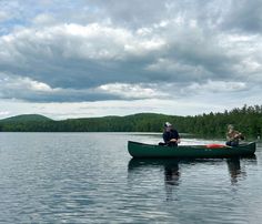 two people in a canoe on the water