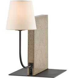 a lamp that is sitting on top of a block with a light bulb attached to it