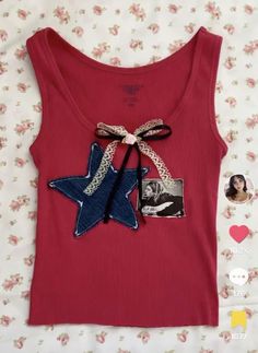 a red tank top with a blue star on the front and a black bow at the back