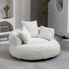 a living room with a round chair and pillows